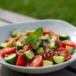 Delicious Cucumber Tomato Avocado Salad served on a picnic table, perfect for summer gatherings.