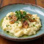 Finished Roasted Garlic Cauliflower Mash, creamy and flavorful, perfect as a side dish.