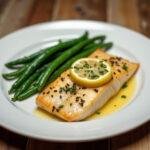 Beautifully plated baked flounder with green beans, elegant dinner presentation.