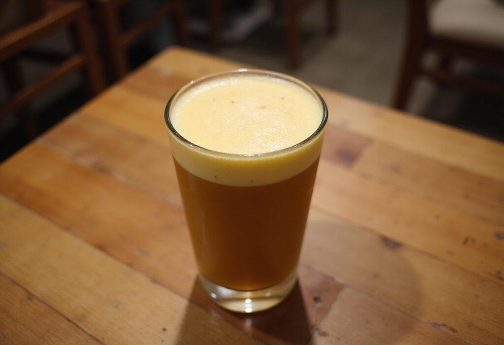 Final presentation of cheese tea sensation in a glass with a frothy cheese layer, capturing the essence of this easy cheese tea recipe in a warm and inviting atmosphere.