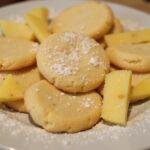 Deliciously golden chewy pineapple cookies displayed on a plate, enticing with their tropical flavor and sweet aroma.