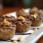 Delicious no bake peanut butter oat cups beautifully displayed on a platter, drizzled with chocolate, perfect for any healthy snack lover.