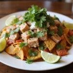Delicious poke nachos supreme served on a wooden table, showcasing fresh poke, vibrant toppings, and crispy tortilla chips, perfect for any gathering.