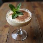 Enjoy a delectable serving of smooth rum cream indulgence, perfectly garnished for a delightful dessert experience.