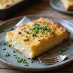 Deliciously served Starbucks potato chive bake slice on a rustic plate, highlighting the creamy texture and chive flavor for a mouth-watering presentation.
