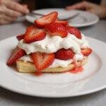 Final presentation of the Strawberry Blonde Delight dessert, highlighting the layers of strawberry and cream that make it a delightful treat.