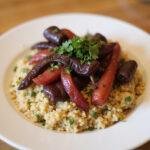 An elegant presentation of quinoa topped with sautéed purple bell peppers, highlighting the culinary versatility and vibrant color of the purple bell pepper.