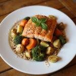 Healthy dinner plate with grilled salmon, roasted vegetables, and quinoa supporting hormonal health.