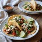 Plate of 3-Step Mediterranean Chicken Tacos with seasoned chicken, fresh vegetables, and herbs, styled in a cozy home kitchen environment, showcasing a warm and inviting presentation.