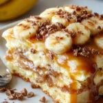 A layered Banana Pudding Tiramisu with caramel drizzle, showcasing mascarpone cream, sliced bananas, ladyfingers, and caramel topping