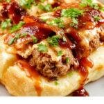 A plate of Bourbon BBQ Bacon Cheeseburger Meatball Subs with melted cheese, crispy bacon, and fresh toppings, served on toasted buns.