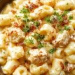 A bowl of Creamy Honey Pepper Chicken Mac & Cheese Delight featuring tender chicken pieces, creamy cheese sauce, and a drizzle of honey topped with black pepper.