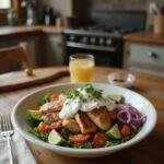 Healthy chicken gyro bowl featuring grilled chicken, fresh vegetables, and yogurt sauce, presented in a cozy home kitchen setting with warm lighting and rustic background elements.