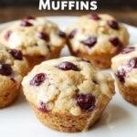 A close-up of healthy Greek yogurt blueberry protein muffins arranged on a rustic wooden table, highlighting their golden tops and plump blueberries.