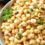 A vibrant bowl of Healthy Street Corn Pasta Salad featuring colorful pasta, roasted corn, cherry tomatoes, fresh herbs, and a light dressing.