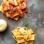 A colorful arrangement of various pasta types like spaghetti, penne, fusilli, and farfalle, showcasing their unique shapes and textures.