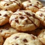 A close-up of golden-brown Butterbeer cookies arranged on a rustic wooden platter, with visible swirls of caramel and a dusting of powdered sugar on top, highlighting their soft and chewy texture, with a hint of vanilla and butterscotch aroma.