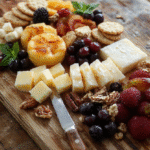 A beautifully arranged cheese board featuring a variety of cheeses, fresh fruits, nuts, and artisanal crackers, styled with elegant serving utensils on a rustic wooden surface, with vibrant colors and textures highlighted.